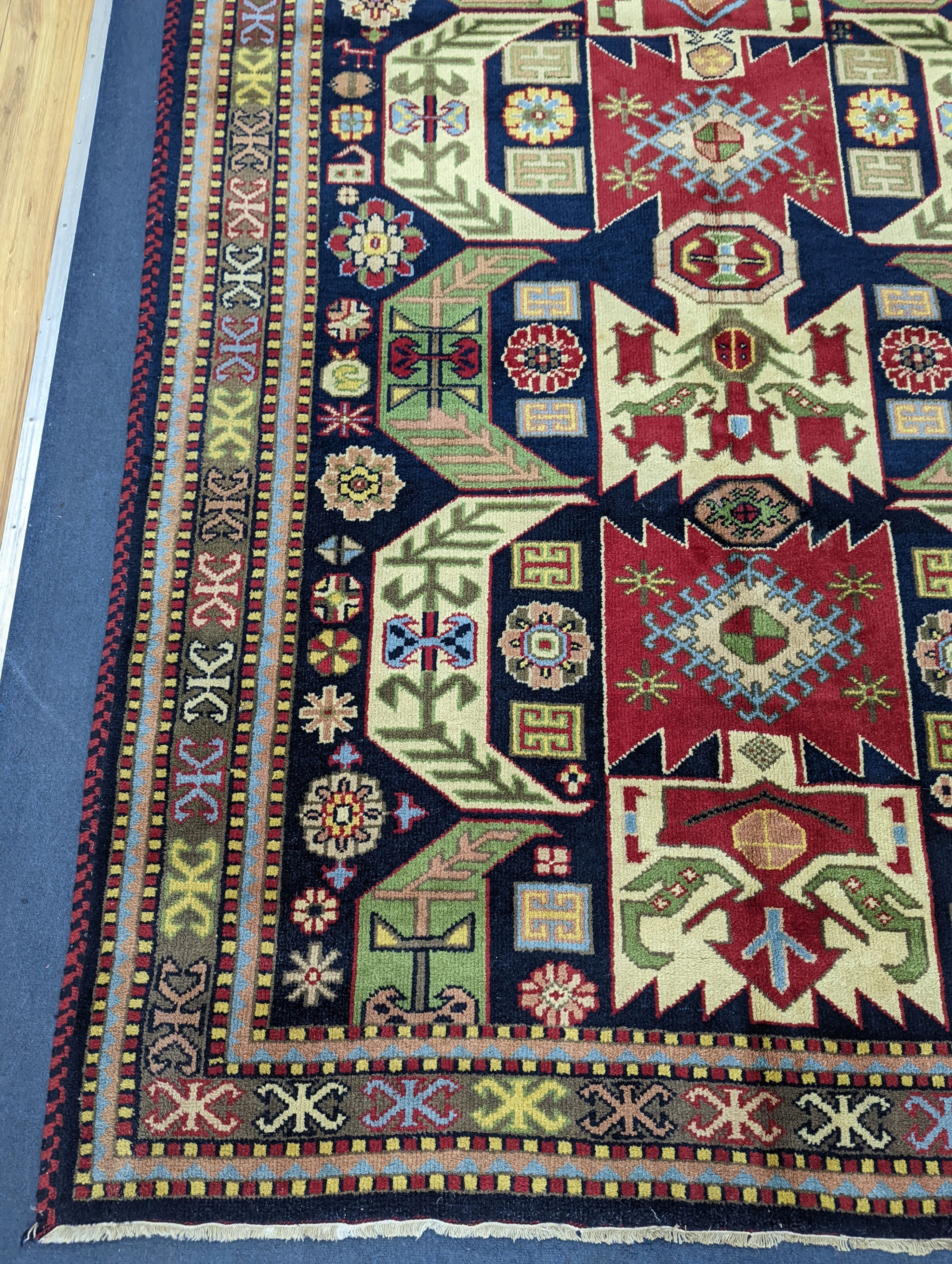 A Caucasian blue ground rug, 240 x 176cm